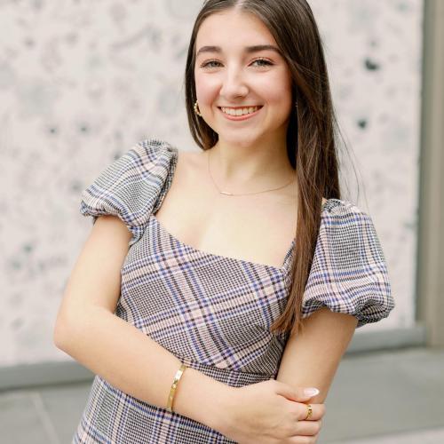 A young woman with long brown hair over one shoulder.