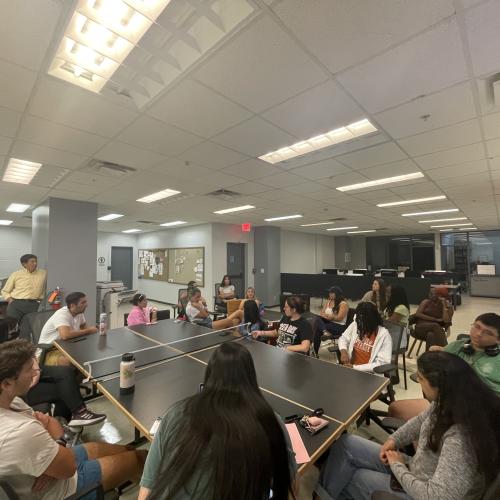 students at meeting around pingpong table